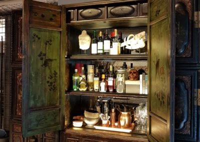 An antique cabinet converted into a bar