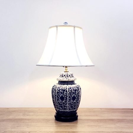 A 6-sided round porcelain table lamp with blue & white double floral designs and a wooden base