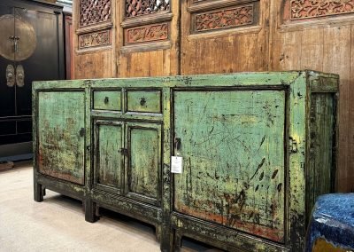 Chinese antique long sideboard in distressed aqua, in front of antique chinese door panels