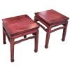 A pair of distressed pink Chinese square stools with hoof feet