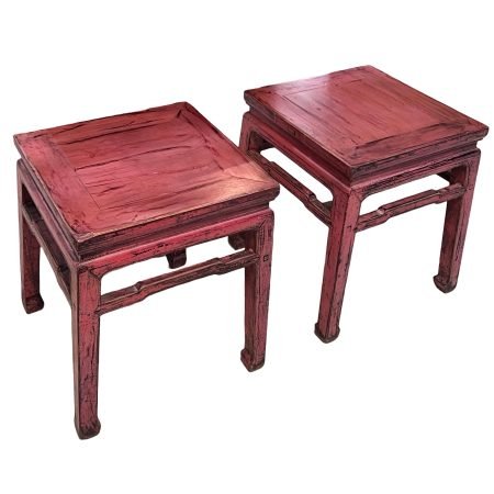 A pair of distressed pink Chinese square stools with hoof feet