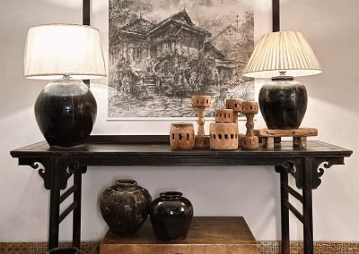 Chinese Ming-style antique black lacquered painter's table, with leather chest and black pots and black pot lamps, and a black & white framed painting