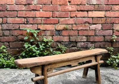 An antique chinese wooden cart driver's low bench