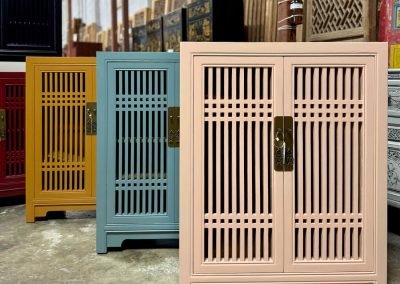 a row of 2-door spindle door shoe cabinets in coral pink, duck egg blue & mustard