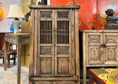 a wooden chinese tapered medium cabinet with carved doors