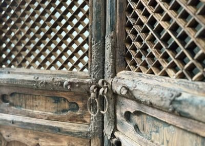 a closer up of the pair of tall chinese antique door panels from Shanxi, with irs original cast iron door handles