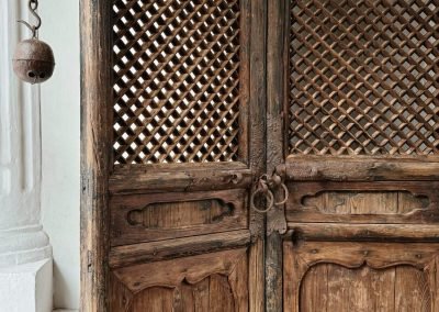 a closer up of the pair of tall chinese antique door panels from Shanxi, with irs original cast iron door handles